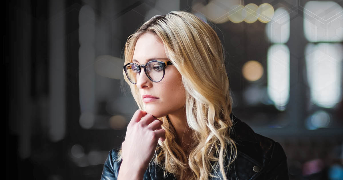 Women with glass thinking with her hand under her chin